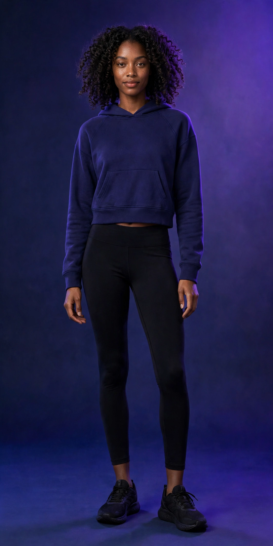 Woman wearing the Omega Woman indigo cropped hoodie, front view