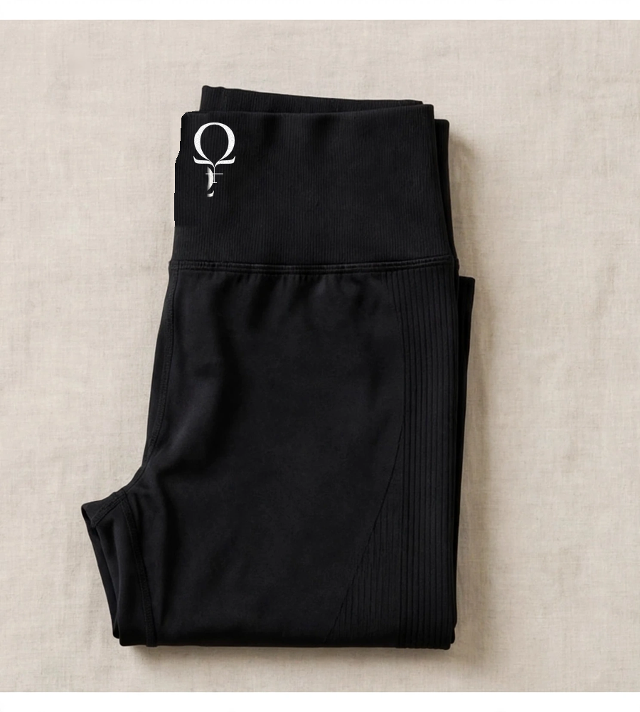 Black high-waisted yoga leggings with a single fused Omega Woman mark on the waistband, shown with the words IRON IN VELVET