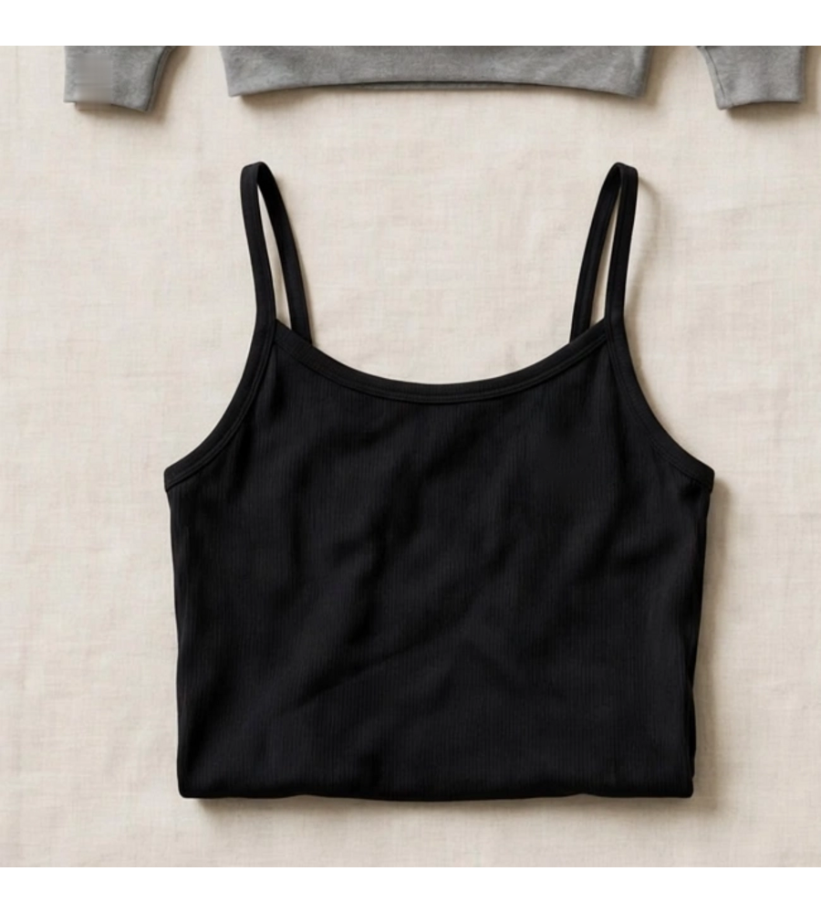 Black yoga crop tank shown with the fused Omega Woman mark and the words GODDESS IN MOTION